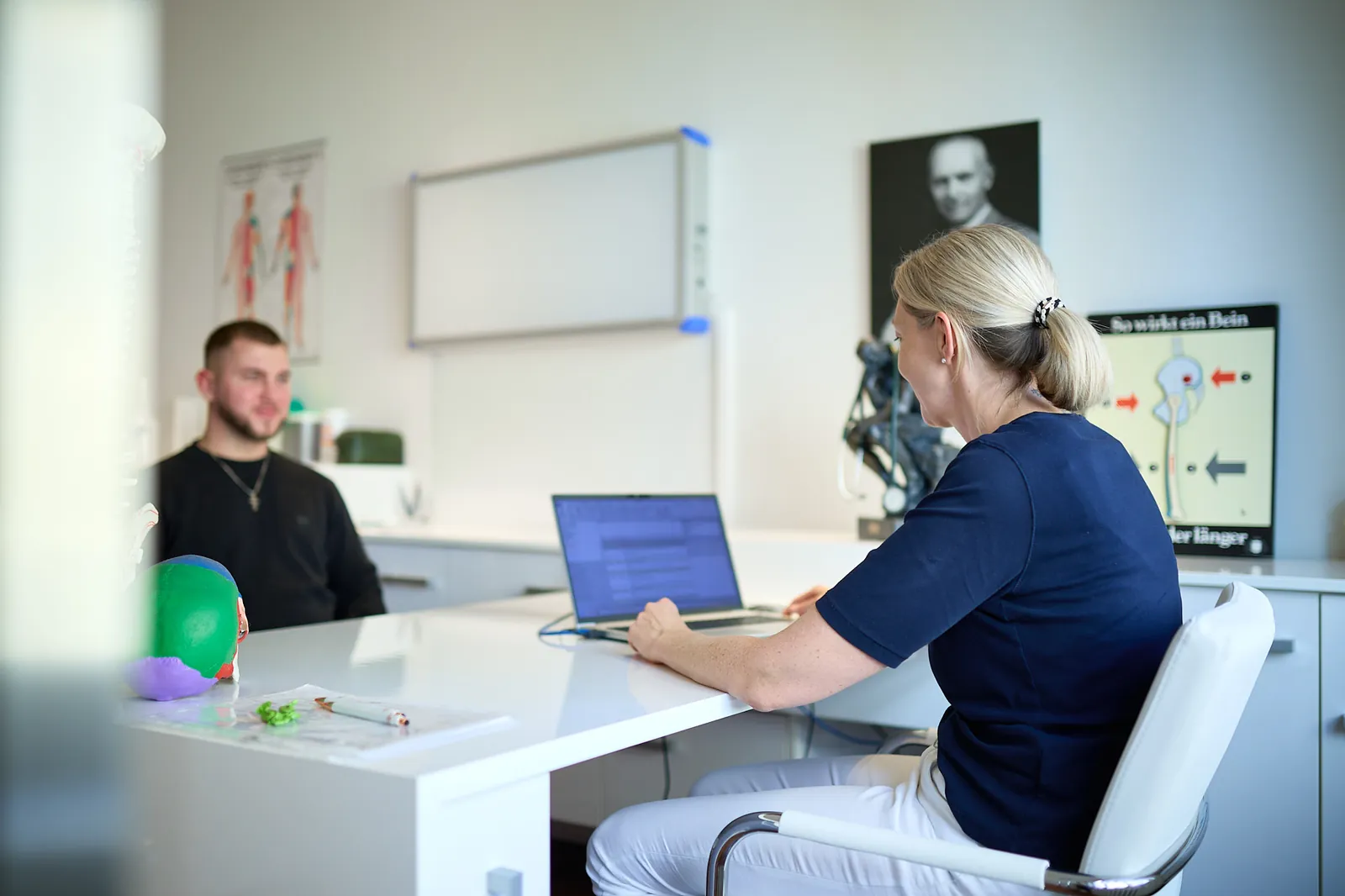 Beratungsgespräch am Schreibtisch in der Praxis Dr. Thiele